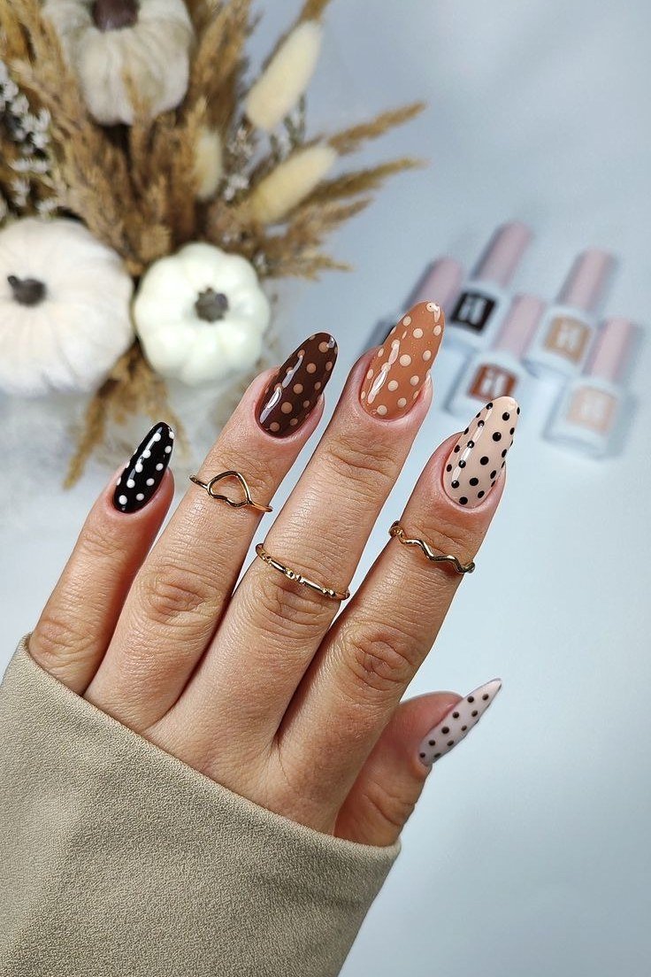 Chocolate cream and burnt orange polka dot almond nails with pumpkin props, festive fall nail art