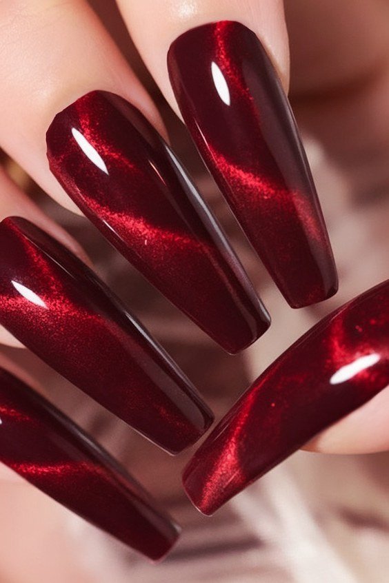 Deep red cat-eye stiletto nails, dramatic fall nail design