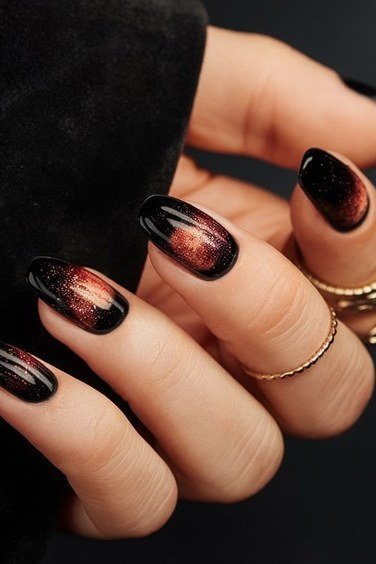 Black and red cat-eye almond nails with white polka dots and rings