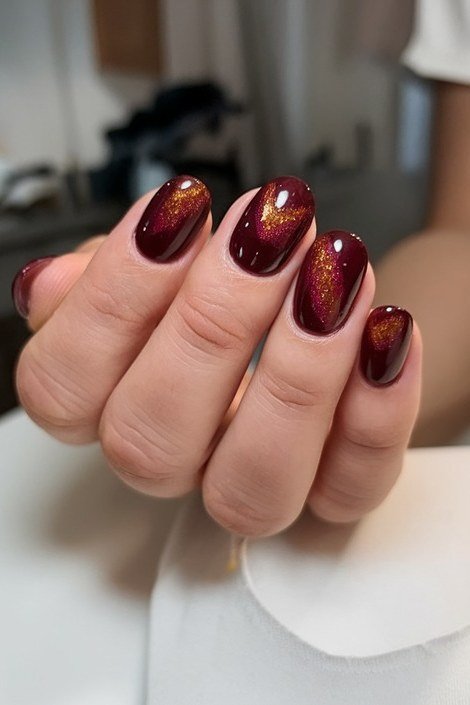 Copper and chocolate cat-eye almond nails with white polka dots
