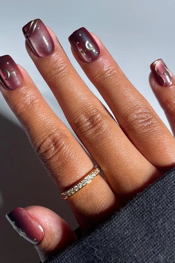 Oxblood squoval nails with white polka dots and a gold ring, fall nail art