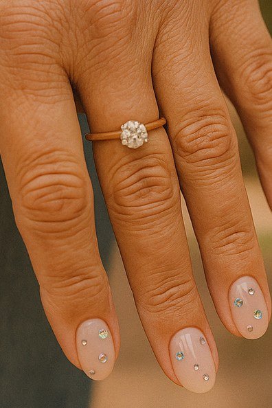 Mature hand with nude nails and tiny dot accents