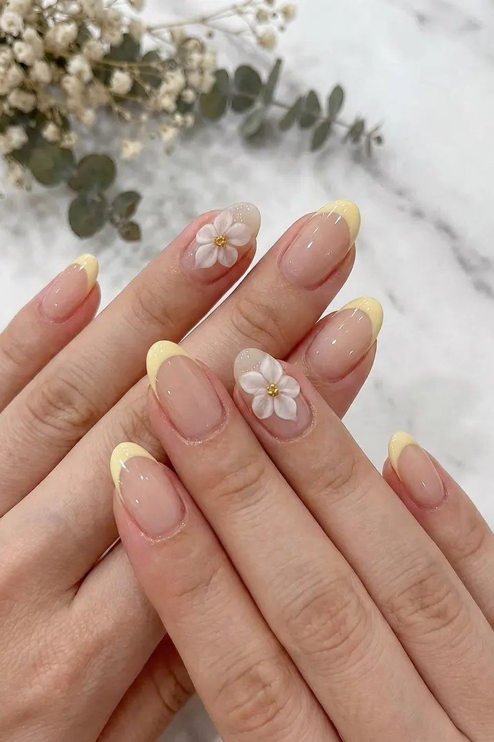 French-tip press-ons with tiny daisy accents