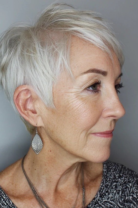 Feathered white pixie haircut for older women, side profile