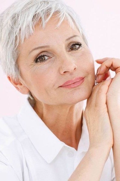 Feathered white pixie with face-framing layers for women over 60