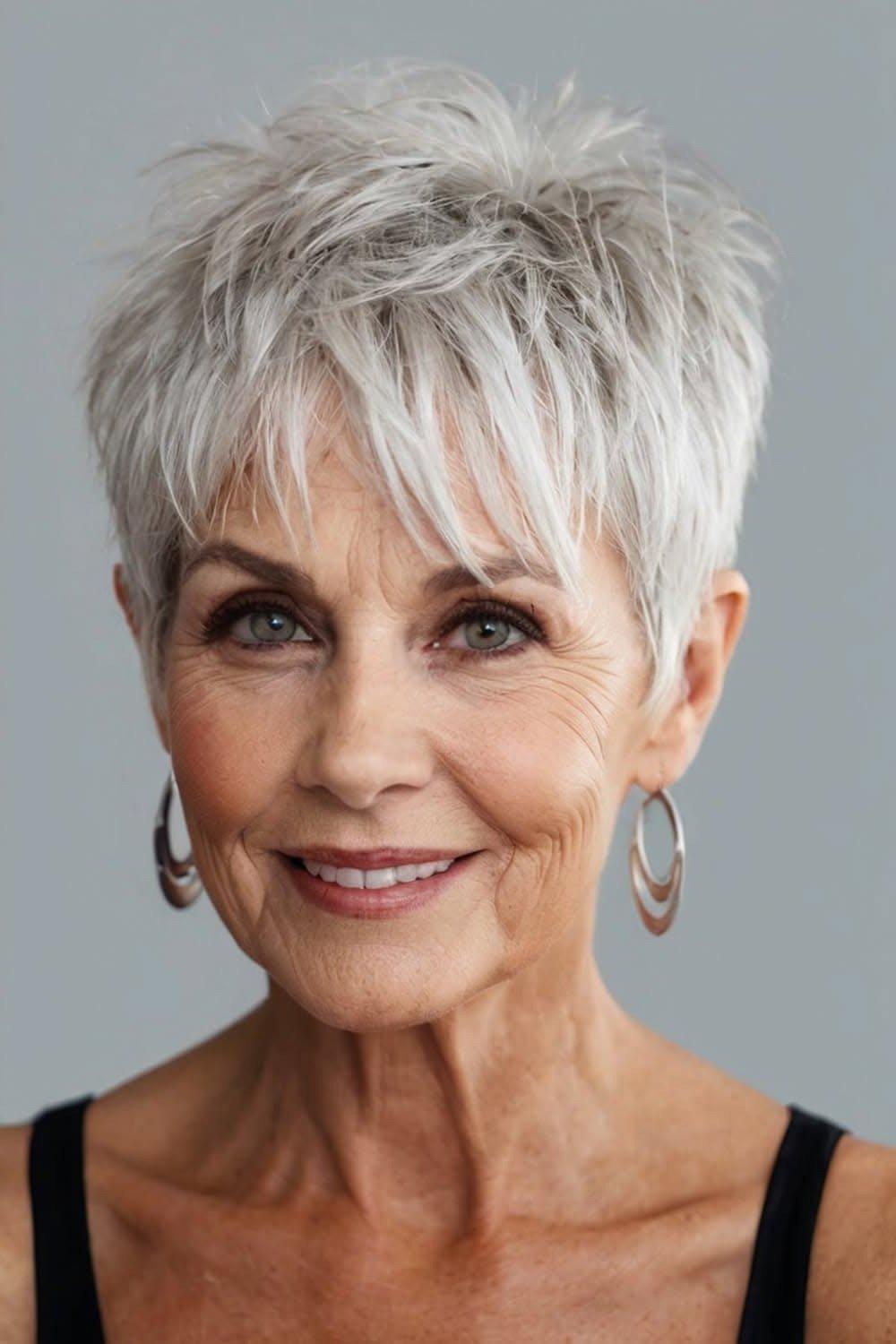 Silver pixie with piecey fringe for women over 60, confident smile