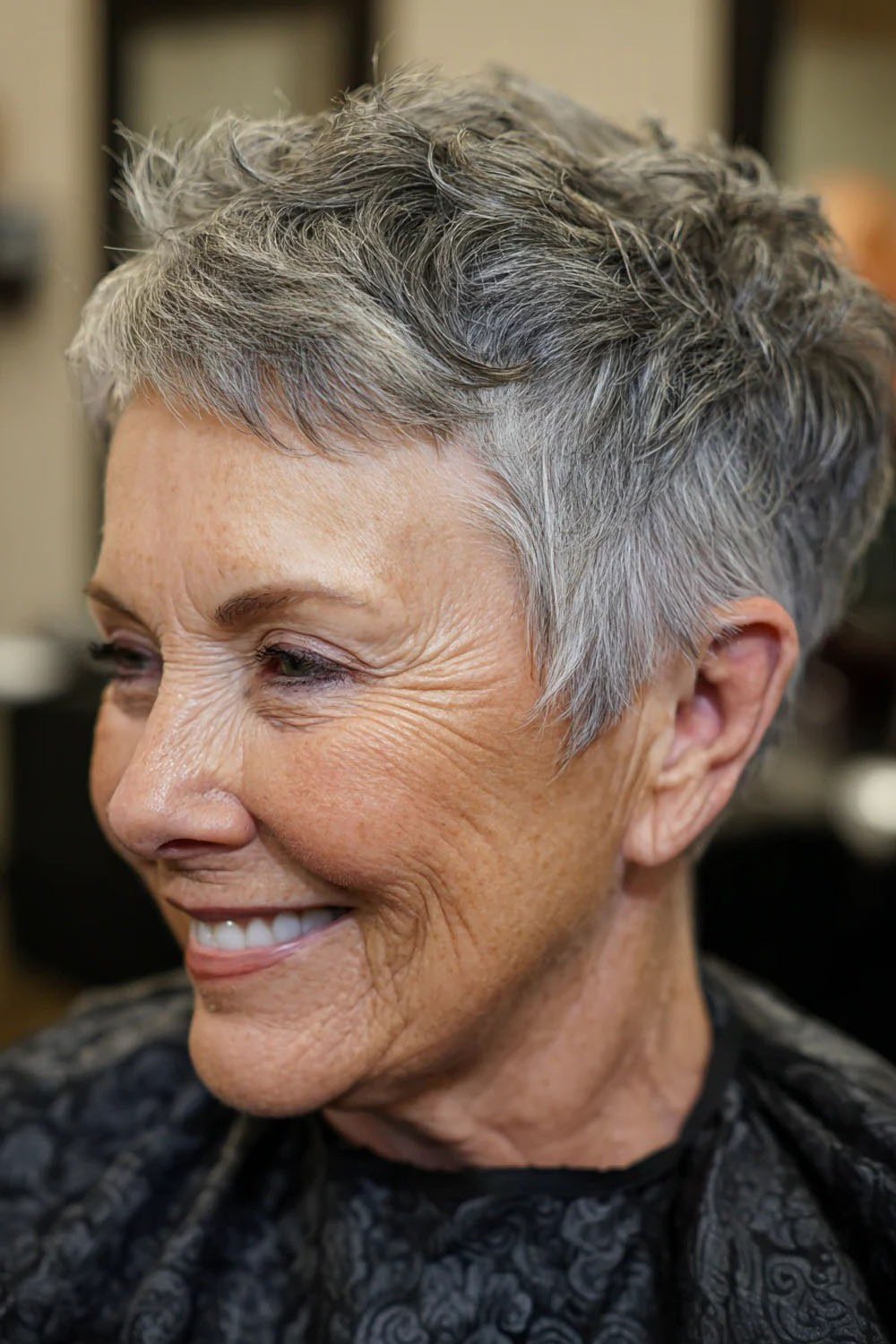 Layered salt-and-pepper pixie for women over 60, side profile