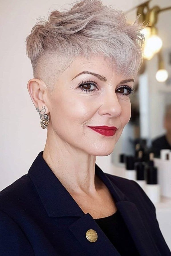 A shaved undercut on one side meets a longer, textured top in this bold pixie.