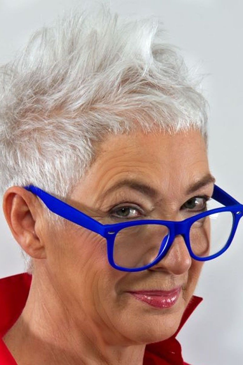 A soft white pixie paired with bold blue glasses is a style masterclass.
