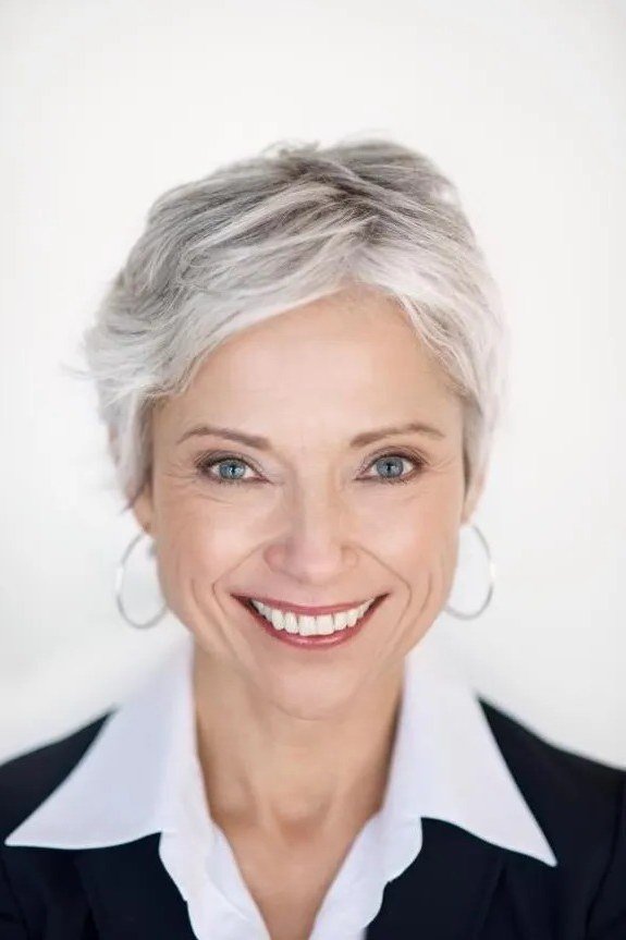 Short, sweet, and full of joy, this white pixie is cut close with soft texture on top.