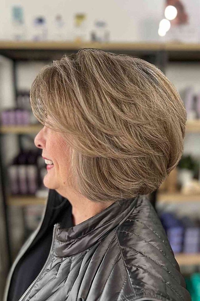 From the side, this ash blonde bob shows gorgeous stacked layers at the back.