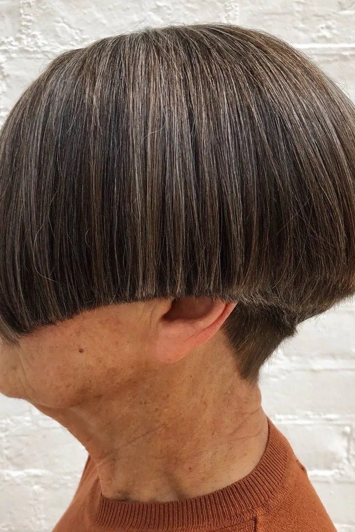 Dark brunette bowl bob with full fringe for older women