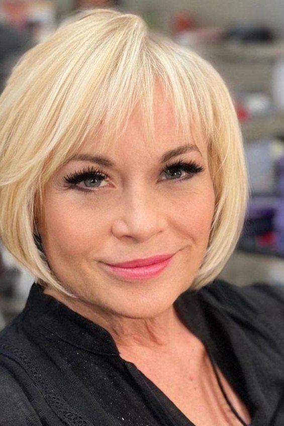 Platinum blonde bob with straight bangs for older women