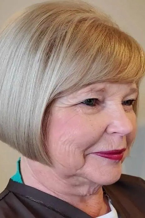 Blonde sleek bob with straight full fringe for older women