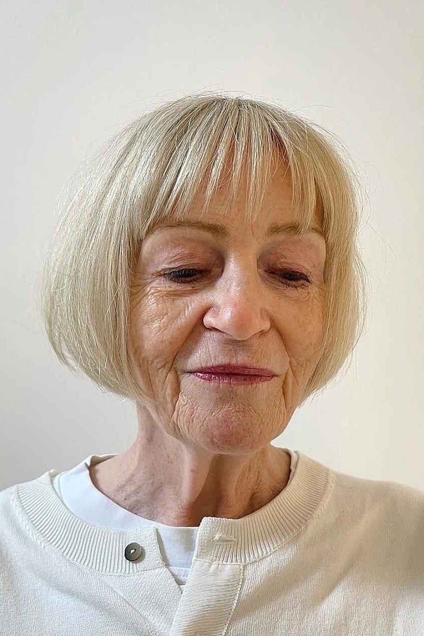 Platinum blonde bob with full straight fringe for older women