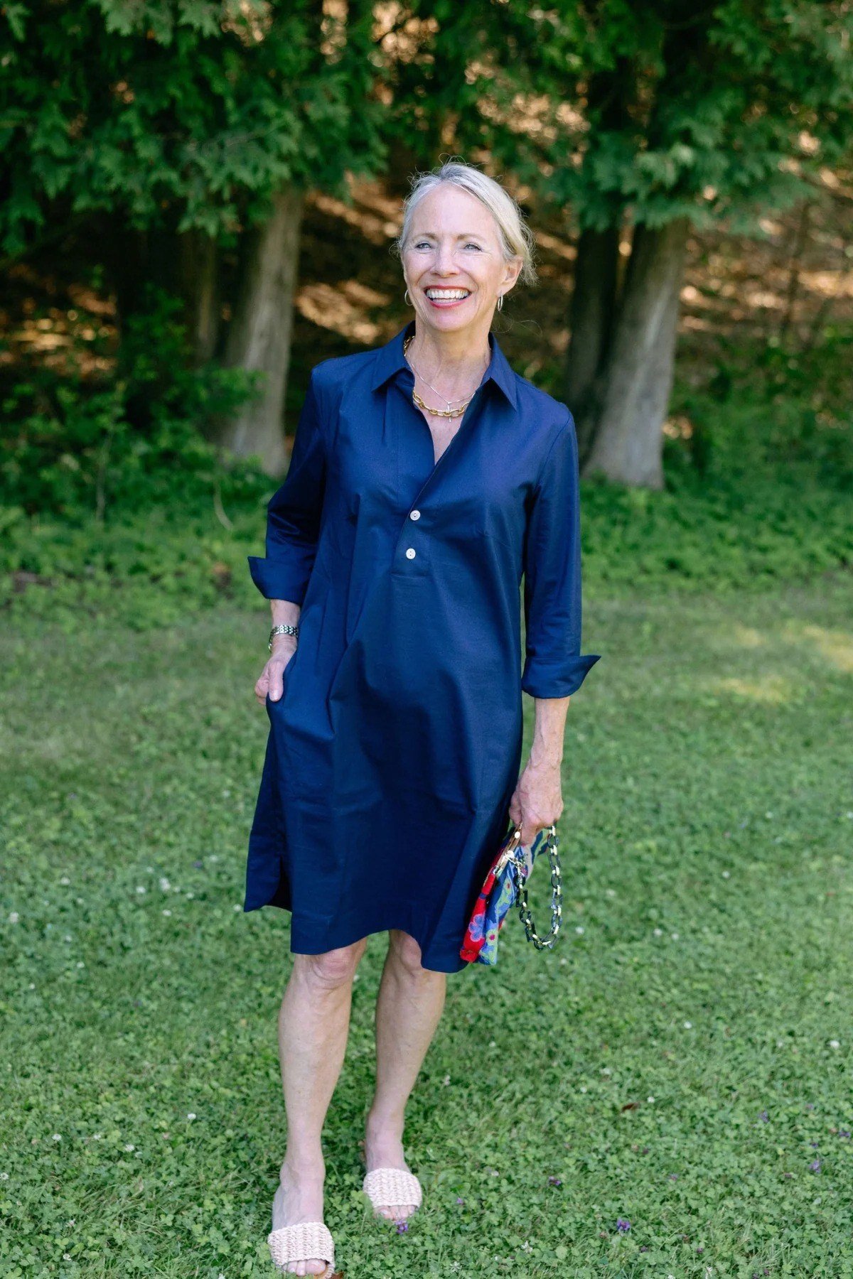 Cobalt blue shirt dress for women over 60: vivid blue with three-quarter sleeves and a small colorful clutch