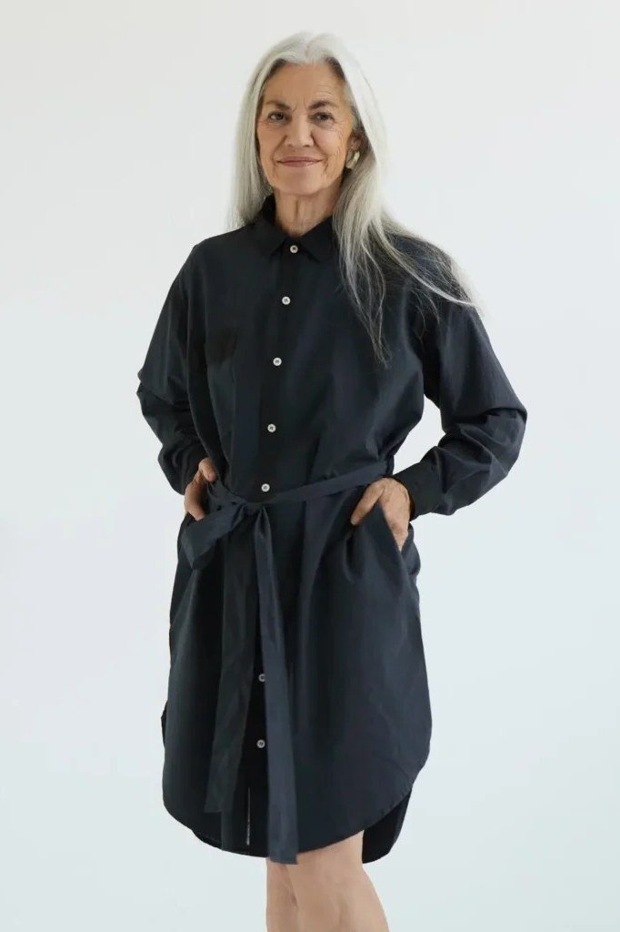 Black tie-belt mini shirt dress for women over 60: sleek black with long sleeves and a self-tie belt