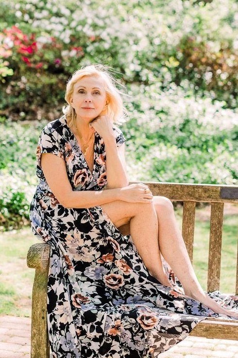 Black floral maxi summer dress for older women on a bench