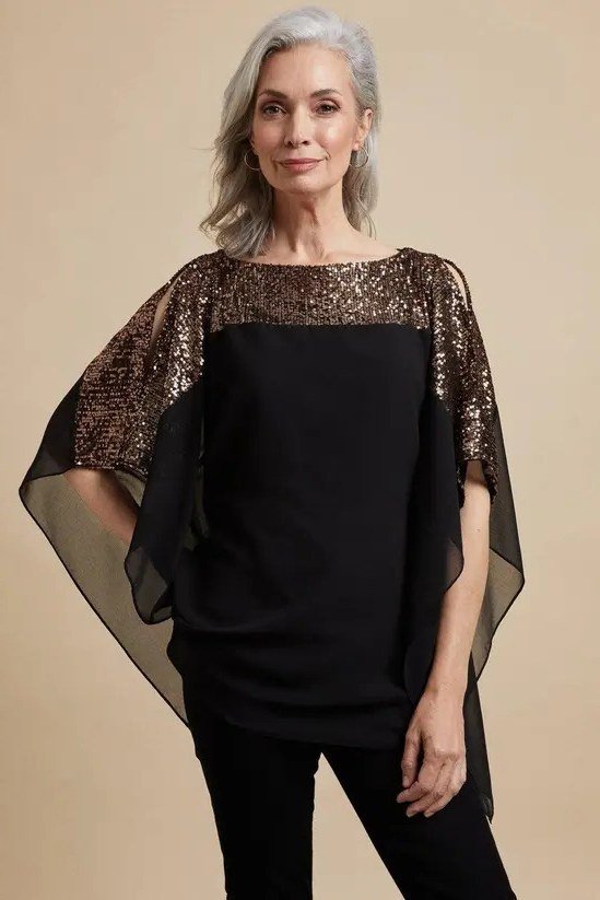 black top with gold sequin cape sleeves, evening outfit for women over 50