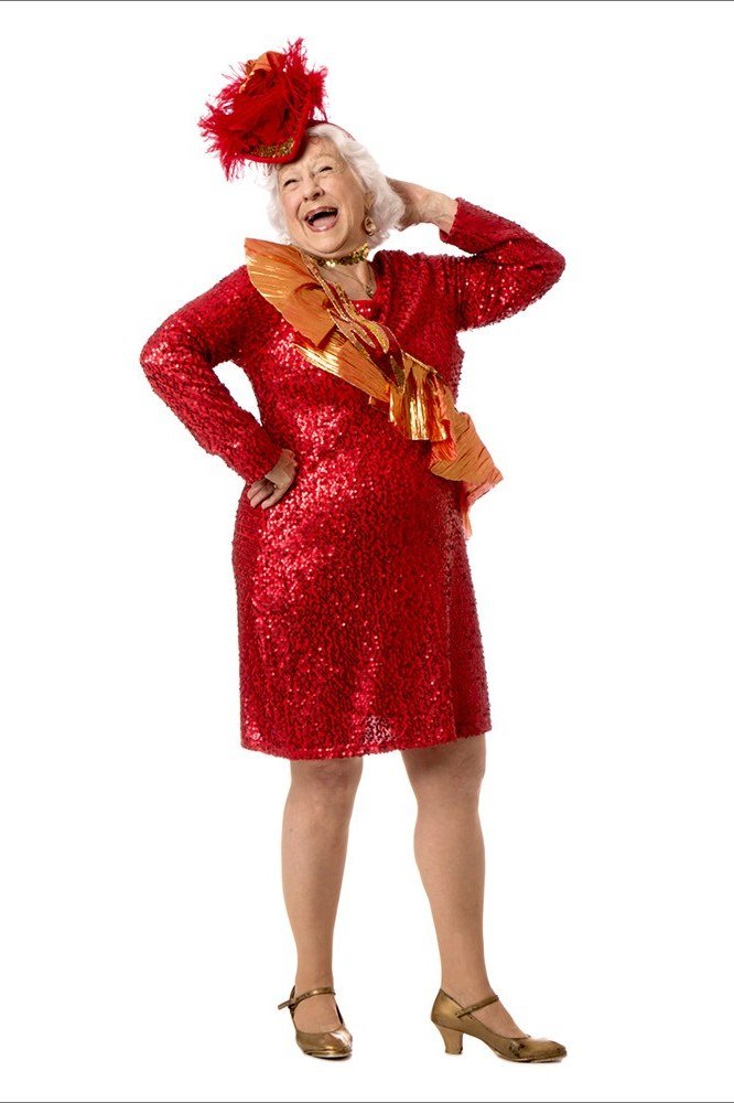 red sequin shift dress with feather fascinator, evening outfit for women over 50