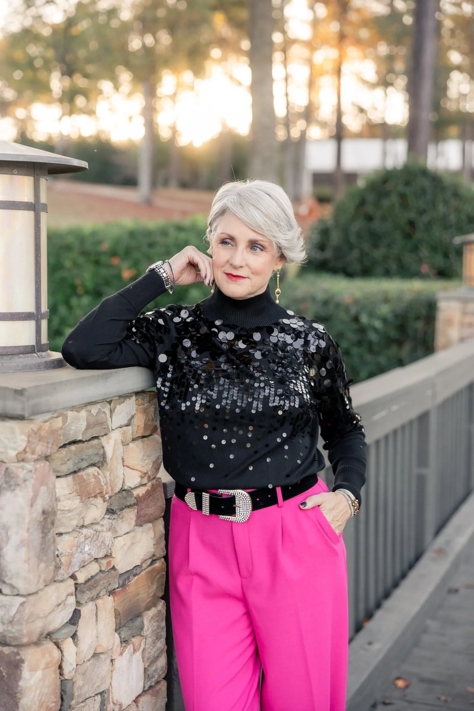 black sequin turtleneck with hot pink trousers, evening outfit for women over 50