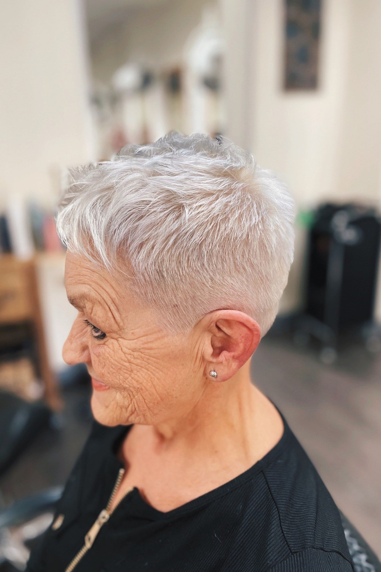 9. Neat White Pixie with a Side Part - short haircut for women over 70 with thin hair