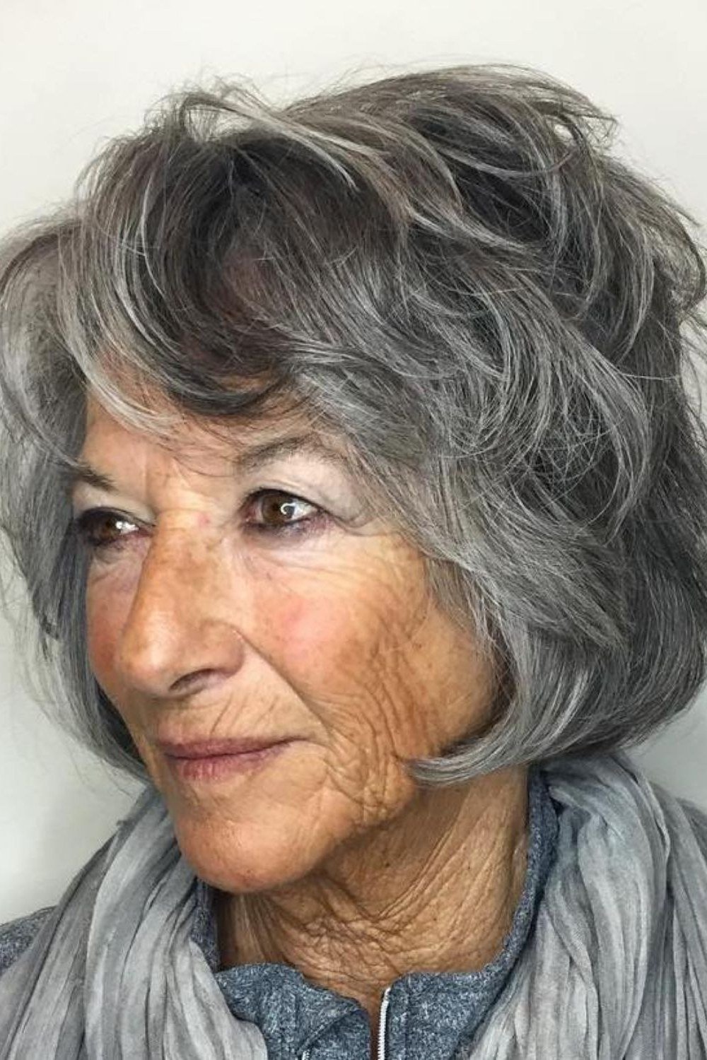 Gray shaggy bob with fringe bangs on a woman over 60 in front view