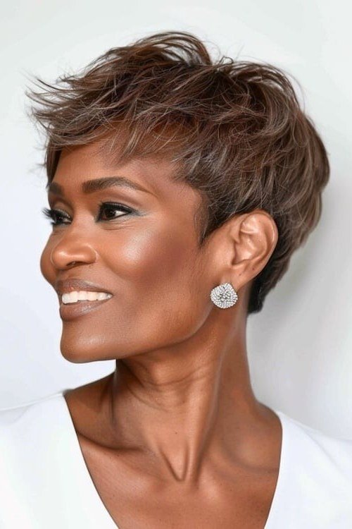 Shaggy pixie bob hairstyle for women over 60: grey shaggy pixie bob, older Black woman, front-side view