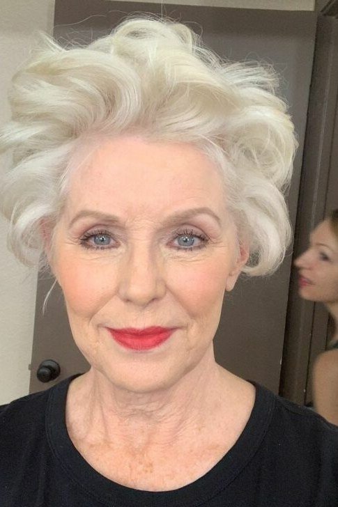 Shaggy pixie bob hairstyle for women over 60: white curly shaggy pixie bob, older woman, front view