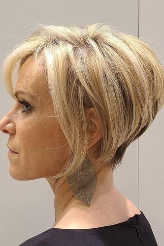 Shaggy pixie bob hairstyle for women over 60: blonde layered shaggy pixie bob, older woman, side view