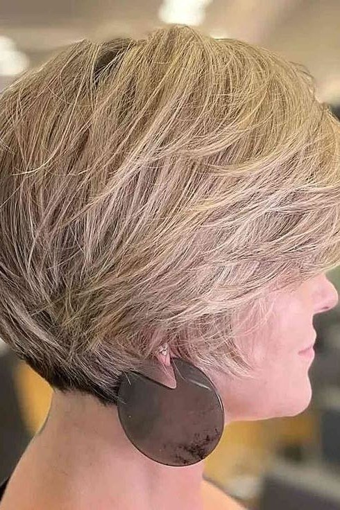 Shaggy pixie bob hairstyle for women over 60: blonde shaggy pixie bob, tapered back, older woman, side view