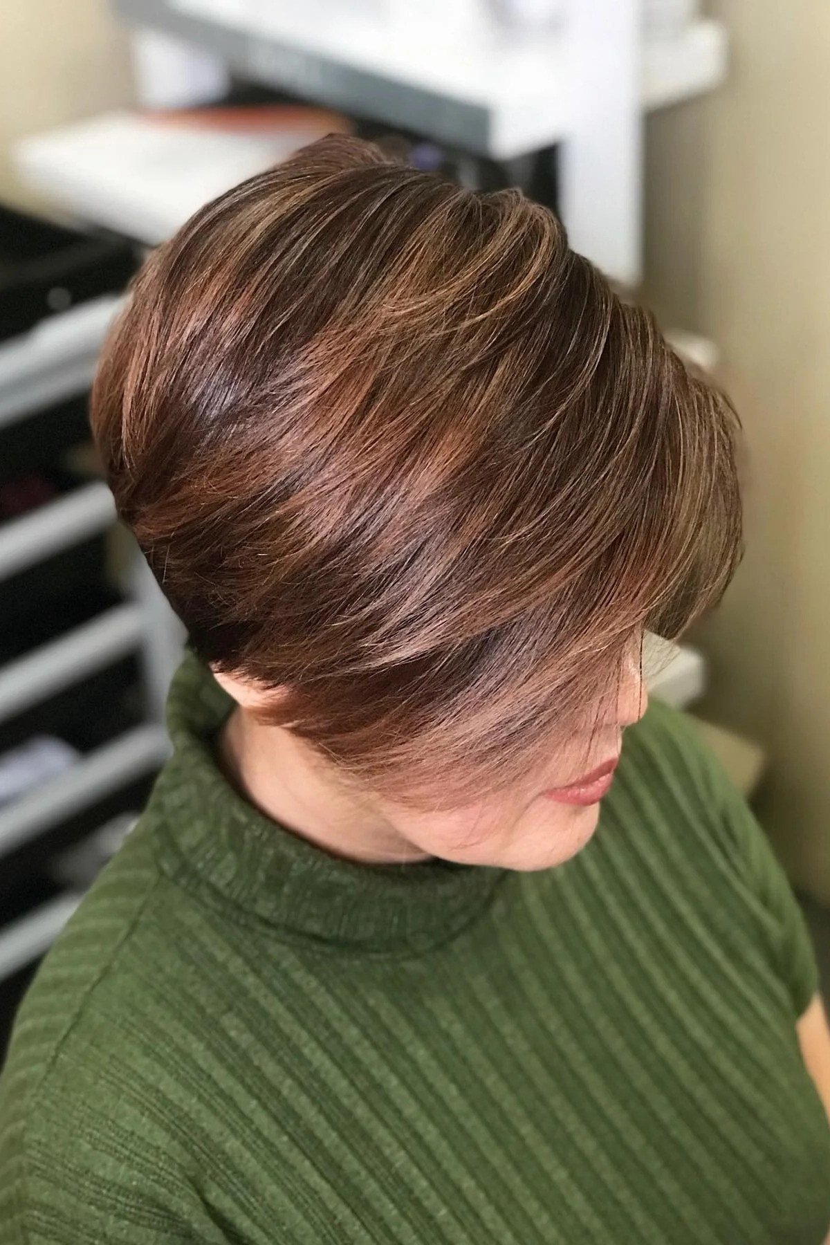 Shaggy pixie bob hairstyle for women over 60: copper textured shaggy pixie bob, older woman, side view