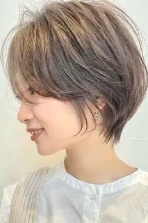 Shaggy pixie bob hairstyle for women over 60: grey-brown shaggy pixie bob, textured, older woman, side view