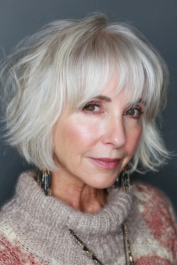 White shaggy bob with bangs, smiling front view - shaggy bob haircut with bangs for women over 60