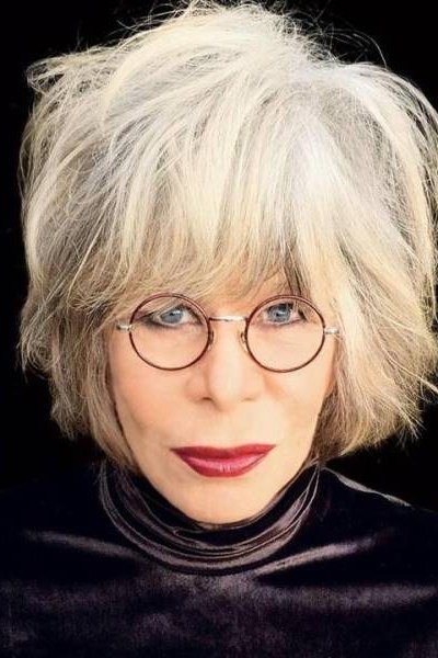 White shaggy bob with glasses for older women, dark background