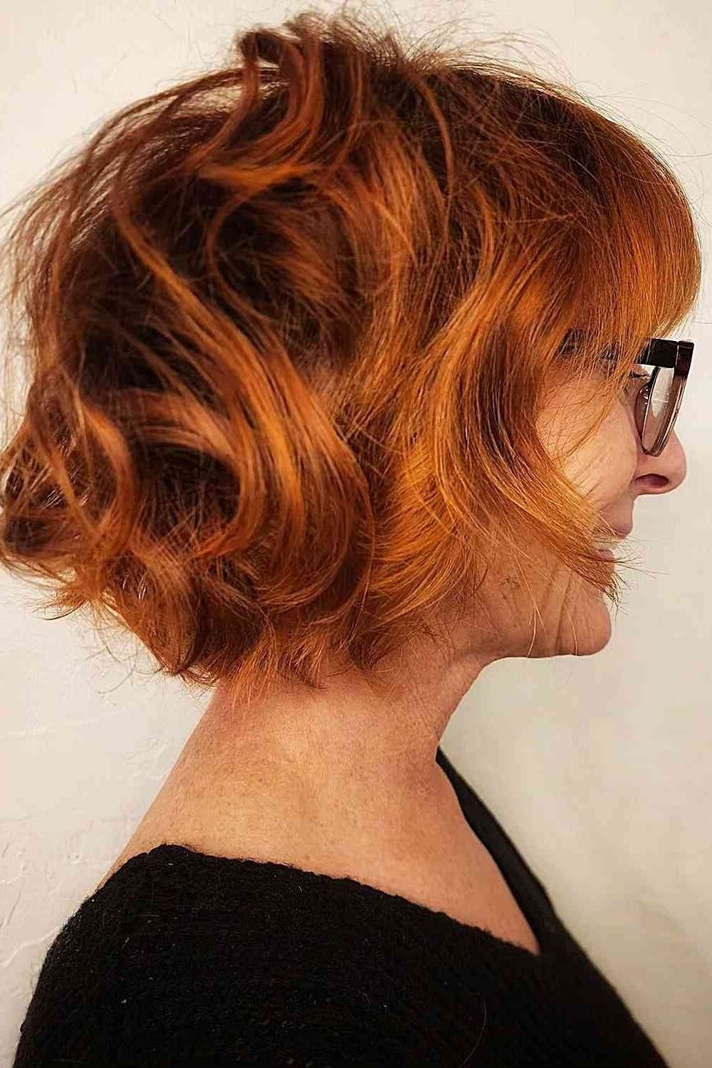 Copper curly shaggy bob with glasses, side view - shaggy haircut for women over 50 with fine hair