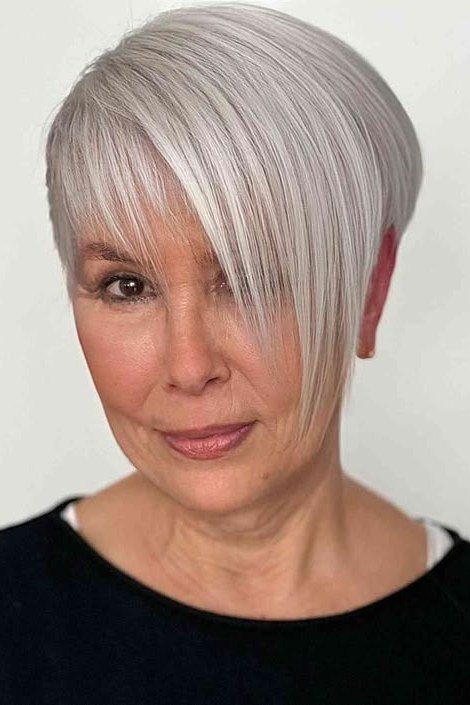 White pixie haircut with long side-swept bang for women over 60