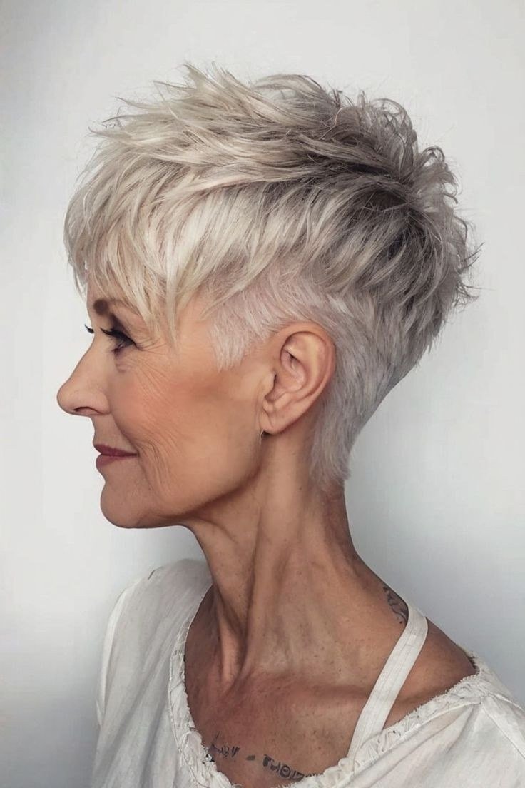 Tapered silver pixie haircut for women over 60, side-front view
