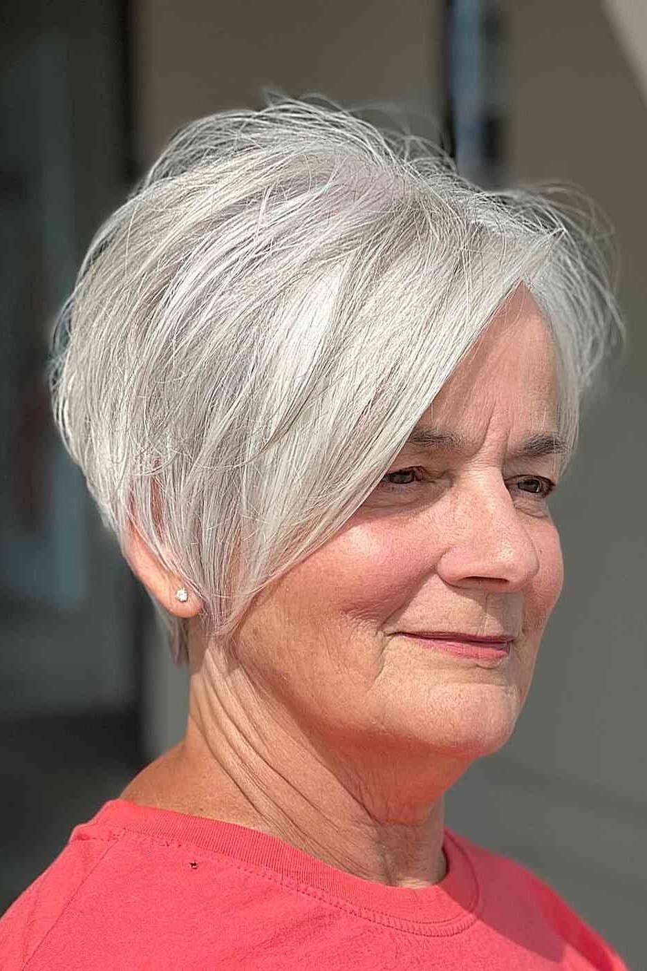 White pixie haircut with side-swept bang for older women