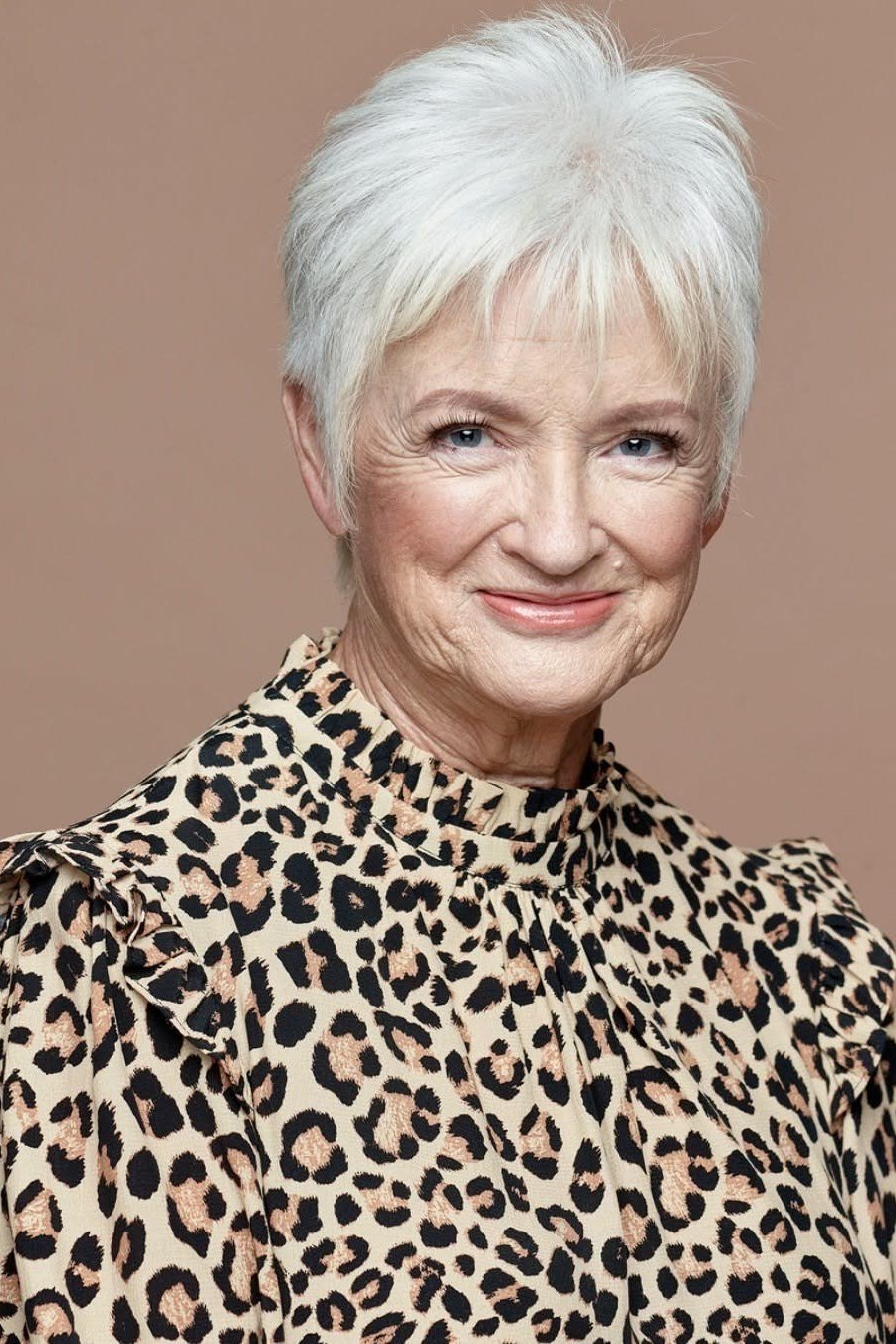 White Pixie with Swept-Forward Layers on a woman over 70