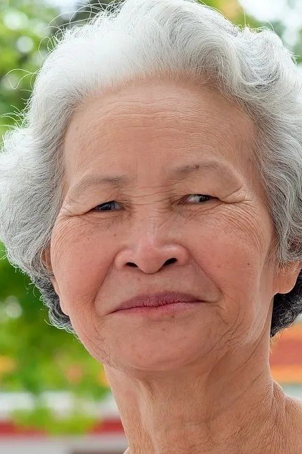 Gray Curly Pixie with Natural Volume on a woman over 70