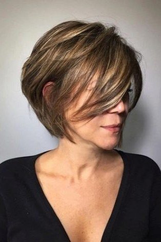 Auburn Layered Bob with Warm Tones on a woman over 70