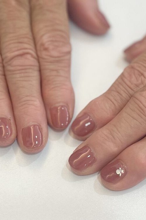 Sheer Mauve Nails with Tiny Star Accents - simple nail design for women over 60
