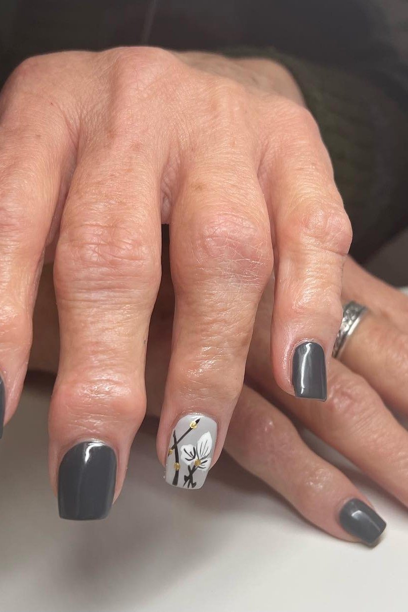 Dark Grey Nails with White Floral Accent - simple nail design for women over 60