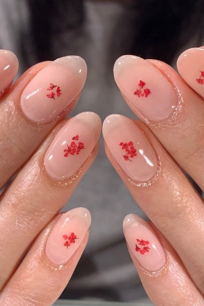 Sheer Nude Nails with Tiny Red Flowers - simple nail design for women over 60