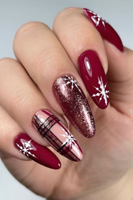 Burgundy nails with white snowflake nail art for women over 60, glossy winter manicure