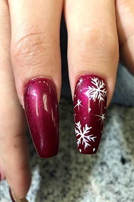 Magenta coffin nails with white snowflake nail art, bold winter manicure design