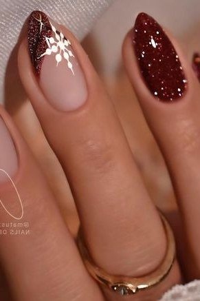 Glitter snowflake accent nails with sparkling winter nail art, festive manicure