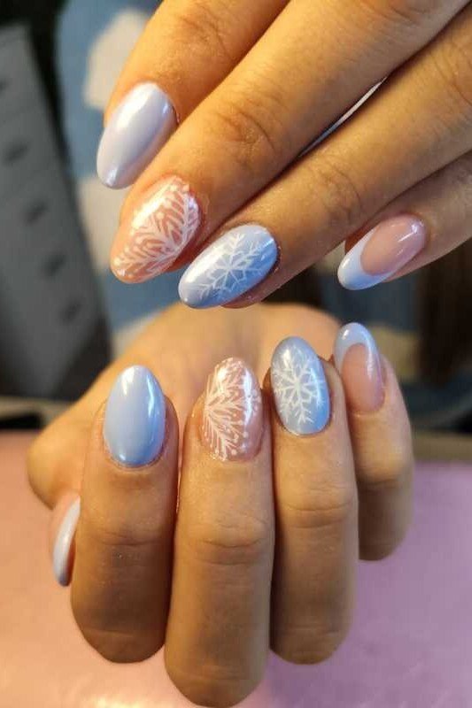 Blue and pink pastel nails with white snowflakes, fresh frosty winter nail art