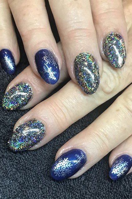 Navy glitter nails with white snowflakes, starry night winter nail art design